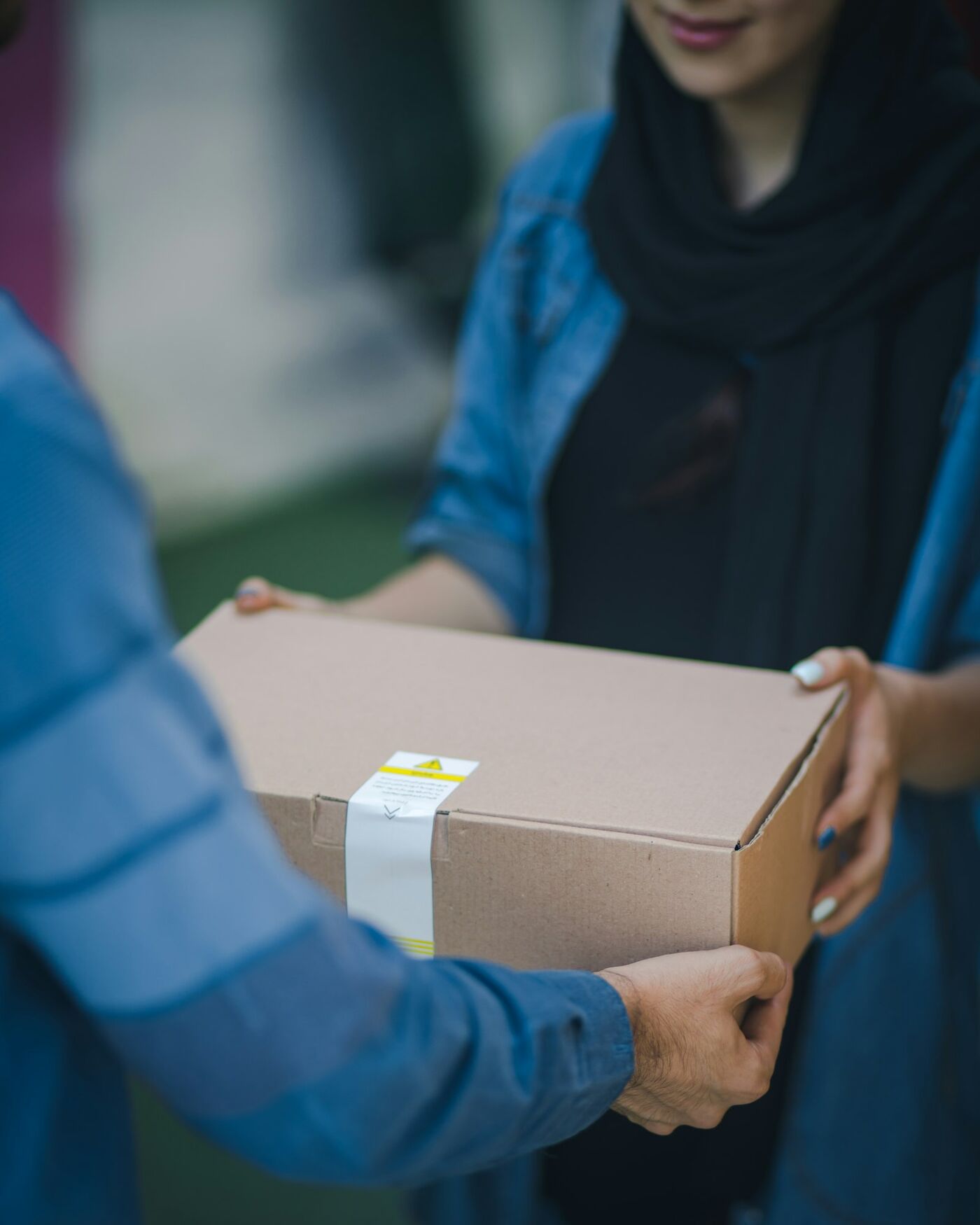 Customer smiling as she receives a parcel delivery