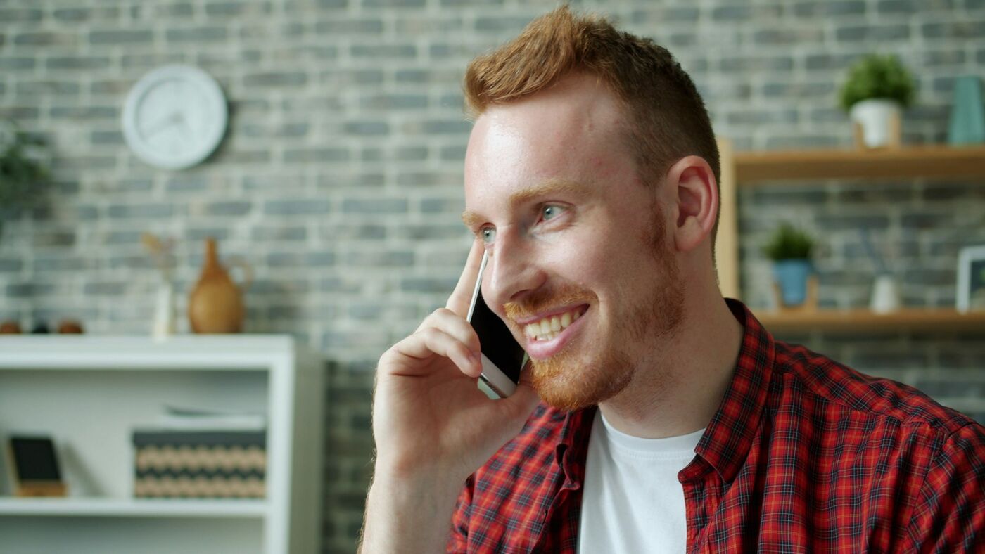 Smiling business owner taking a customer phone call